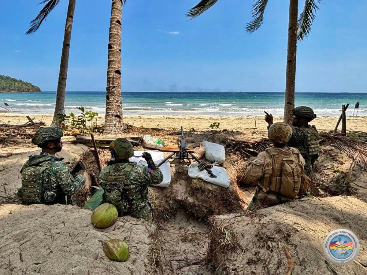 Philippine and United States Marines maintain a defensive posture in a beachfront trench during the Counter-Landing Live Fire Exercise at Apurawan Beach in Aborlan, Palawan on April 27, 2026 as part of Exercise Balikatan. (Photo by 3rd Marine Brigade, Philippine Marine Corps)