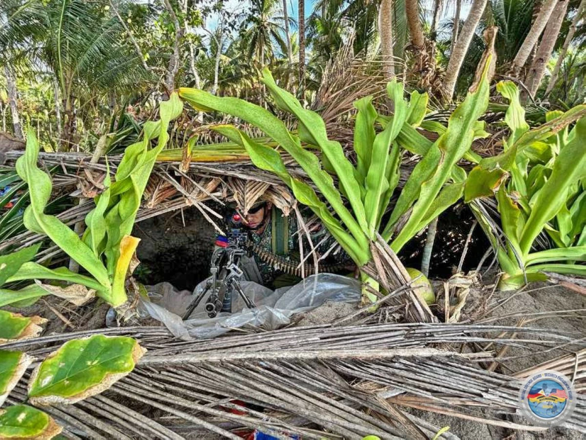 A Philippine Marine provides precision overwatch from a concealed littoral fighting hole during the Counter-Landing Live Fire Exercise at Apurawan Beach in Aborlan, Palawan on April 27, 2026 as part of Exercise Balikatan. (Photo by 3rd Marine Brigade, Philippine Marine Corps)