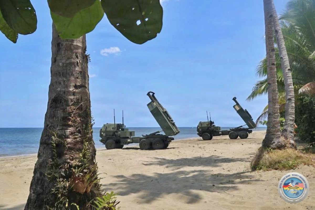 Two United States High Mobility Artillery Rocket Systems (HIMARS) stand ready on the coastline during the Counter-Landing Live Fire Exercise at Apurawan Beach in Aborlan, Palawan on April 27, 2026 as part of Exercise Balikatan. (Photo by Staff Sgt. Brandon Rickert, 7th Infantry Division, US Army)