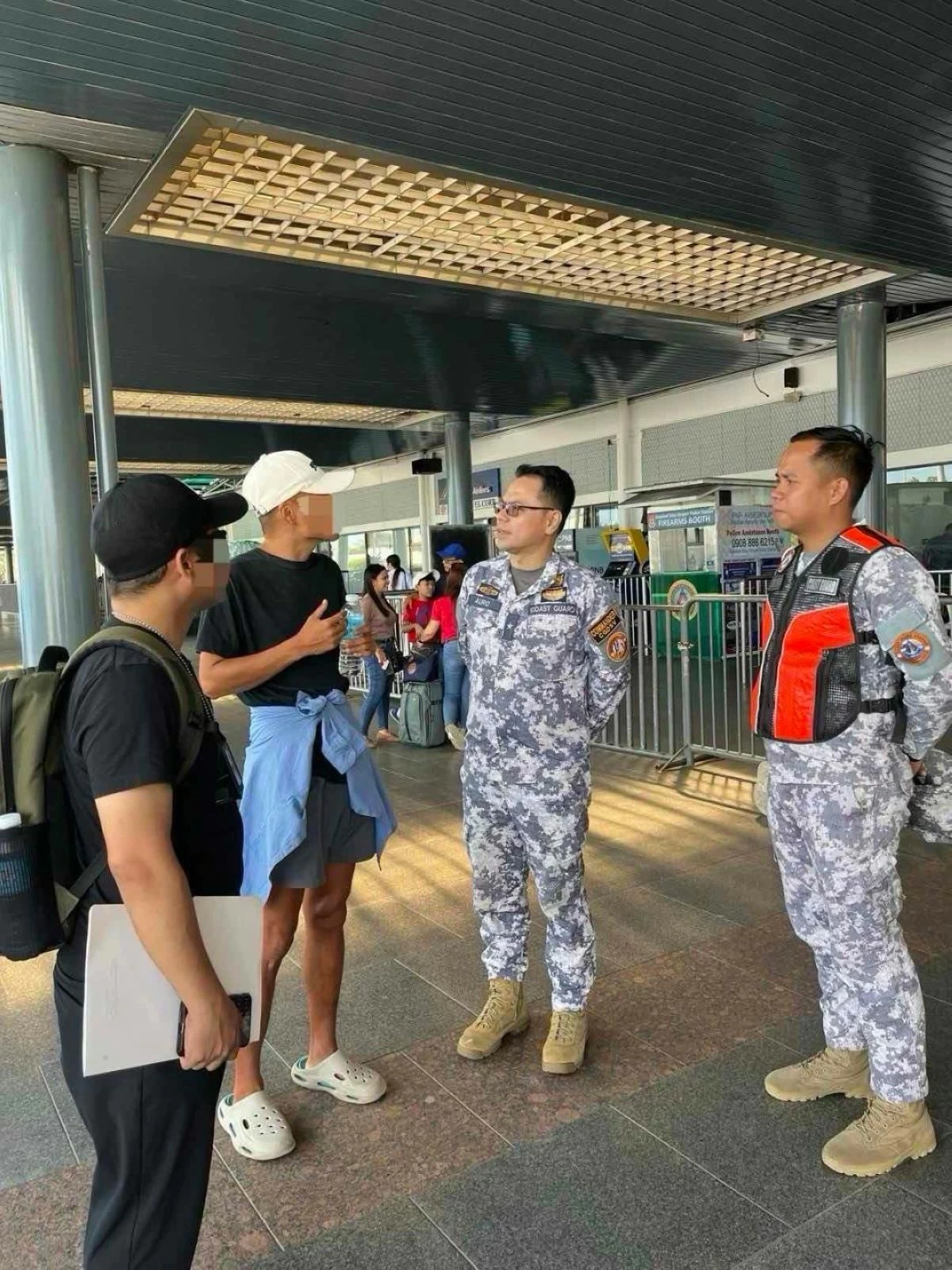 COMMODORE Christopher Auro, commander of the Philippine Coast Guard District Southern Visayas, speaks to an alleged undocumented Chinese who was stopped in a seaport in Barangay Mantaangan, E.B. Magalona, Negros Occidental on Tuesday, April 28, after attempting to board a vessel bound for Ajuy, Iloilo. (PCGDSV)