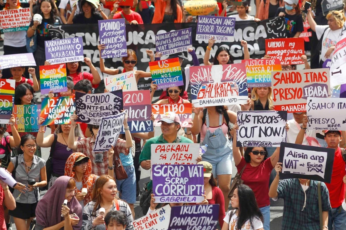 Rallyists carry placards and flags during the Labor Day protest in Manila, voicing calls for stronger labor protections amid rising economic pressures.