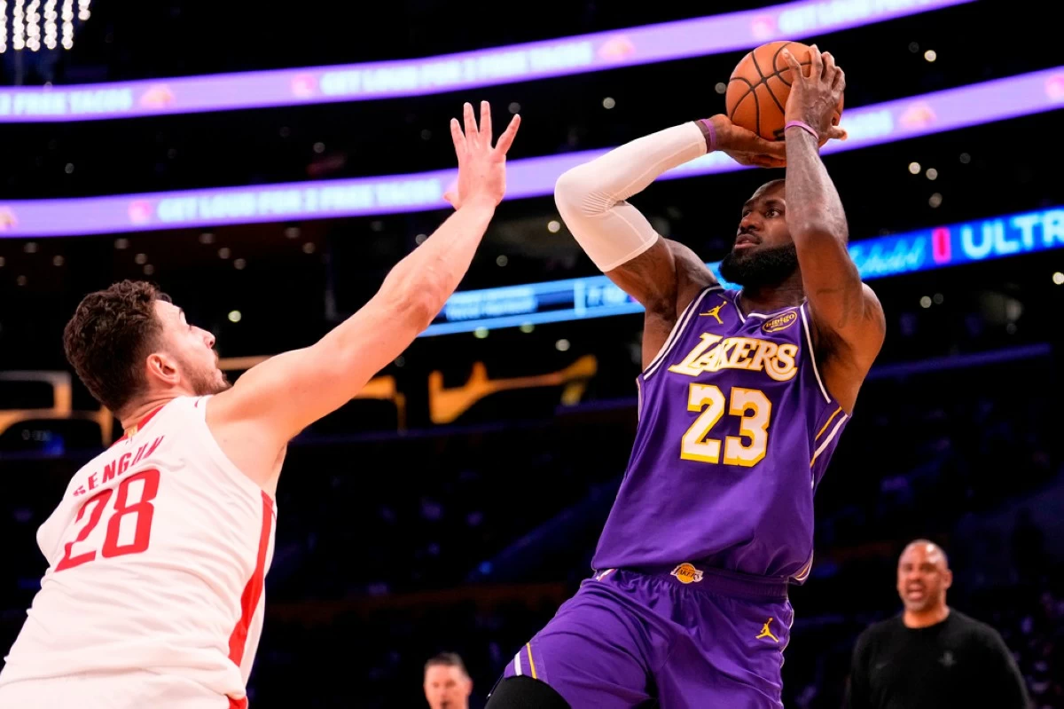Los Angeles Lakers forward LeBron James, right, shoots as Houston Rockets center Alperen Sengun defends during the first half in Game 5 of a first-round NBA playoffs basketball series Wednesday, April 29, 2026, in Los Angeles. (AP Photo/Mark J. Terrill)