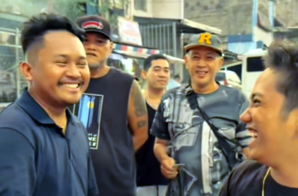 Taguig SK Chairman Ivan Guzman (left) giving out helmets to motorists (Screenshot from Ivan Guzman's Facebook video) 
