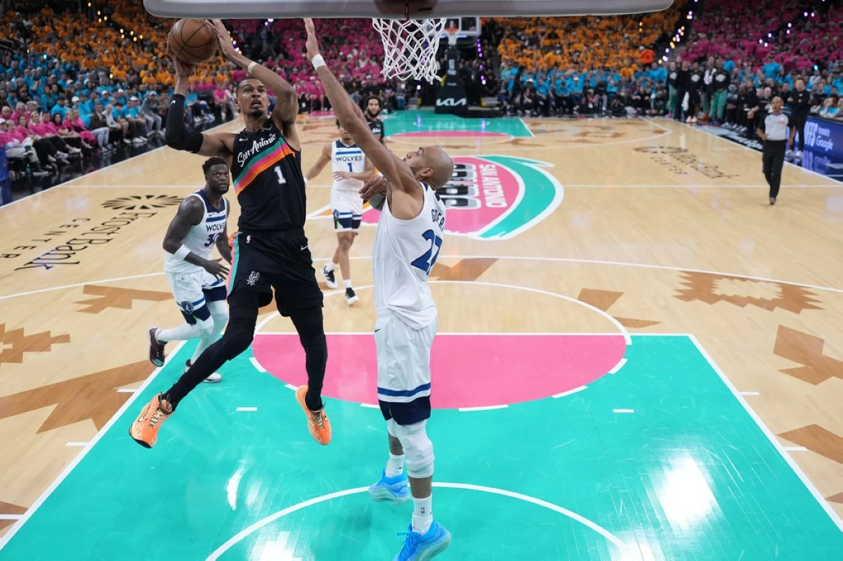 San Antonio Spurs forward Victor Wembanyama (1) shoots while defended by Minnesota Timberwolves center Rudy Gobert (27) during the first half in Game 1 of a second-round NBA playoffs basketball series in San Antonio, Monday, May 4, 2026. (AP Photo/Eric Gay)