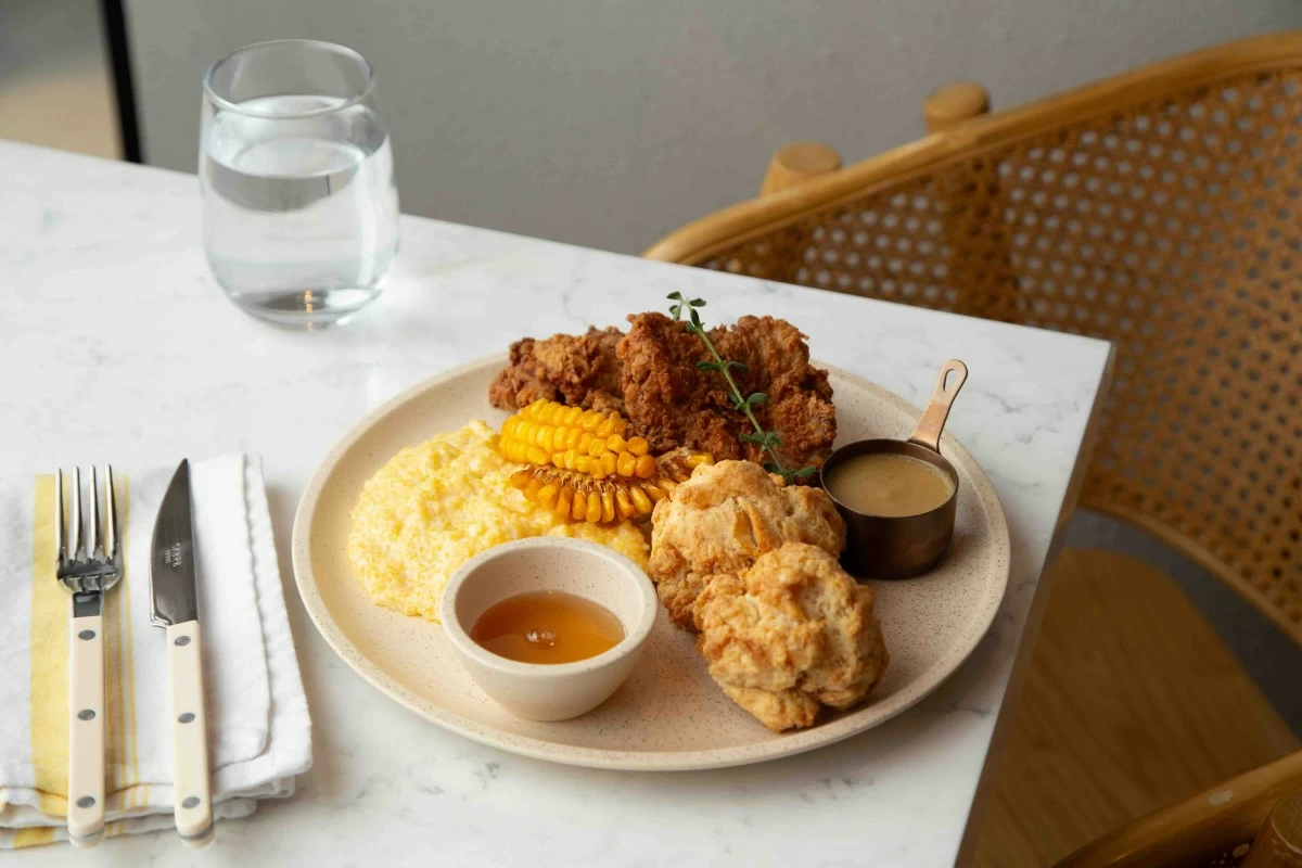 COMFORT PLATE Chicken and Biscuits with buttermilk fried chicken, honey biscuits, corn grits, and herbed gravy. (Photo: Flour Pot Bistro and Bakery)
