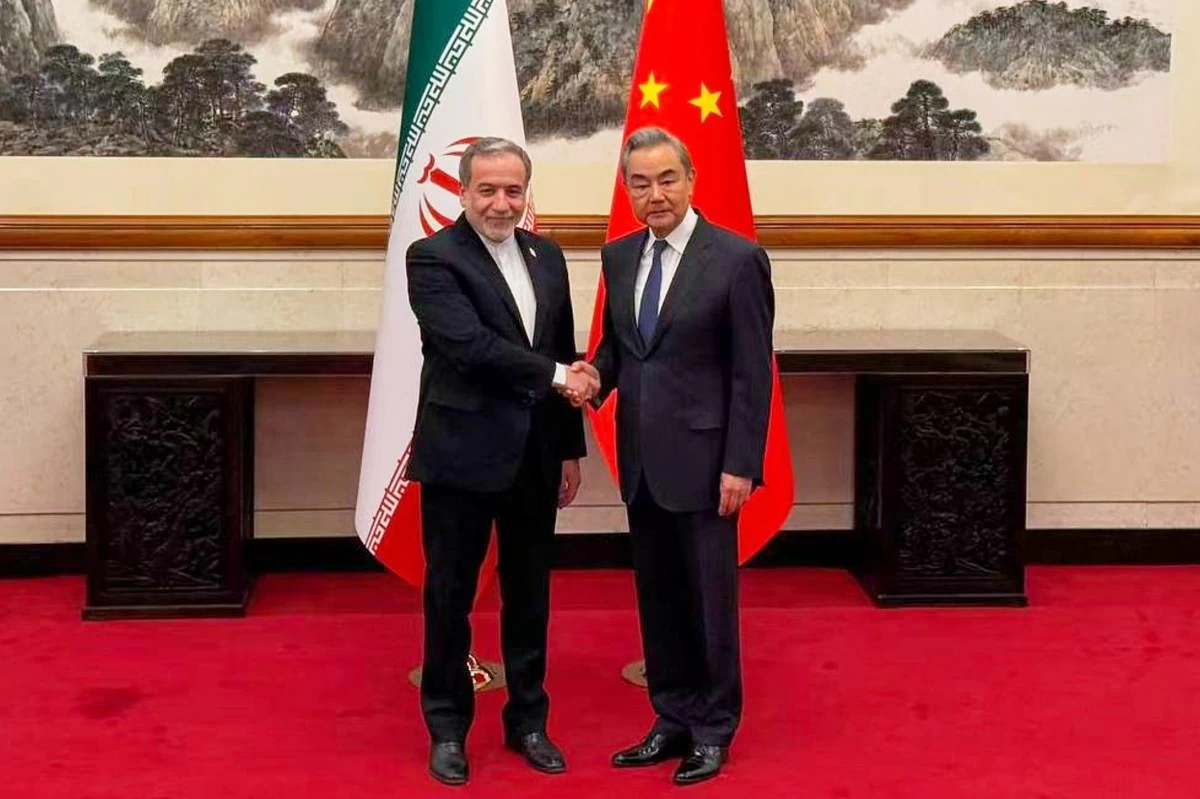 In this photo released by the Telegram channel of Iranian Foreign Minister Abbas Araghchi, China's Foreign Minister Wang Yi, right, meets with Iran's Foreign Minister Abbas Araghchi in Beijing, China, Wednesday, May 6, 2026. (Telegram channel of the Iranian Foreign Minister via AP)