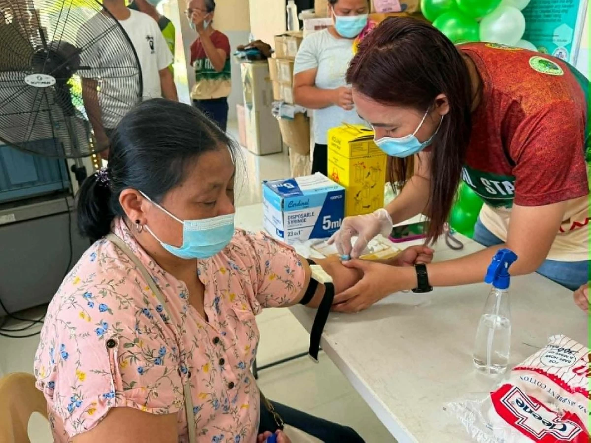 A HEALTH worker collects blood samples from a patient during the launching of the  free laboratory and diagnostic services at the Municipal Super Health Center in Mawab, Davao de Oro. (Mawab LGU) 


