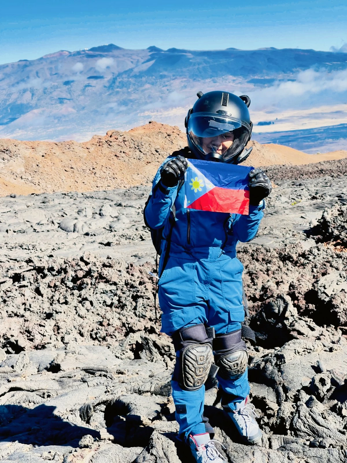 PINOY PRIDE—Kristine Atienza proudly displays the Philippine flag during her analog mission. 