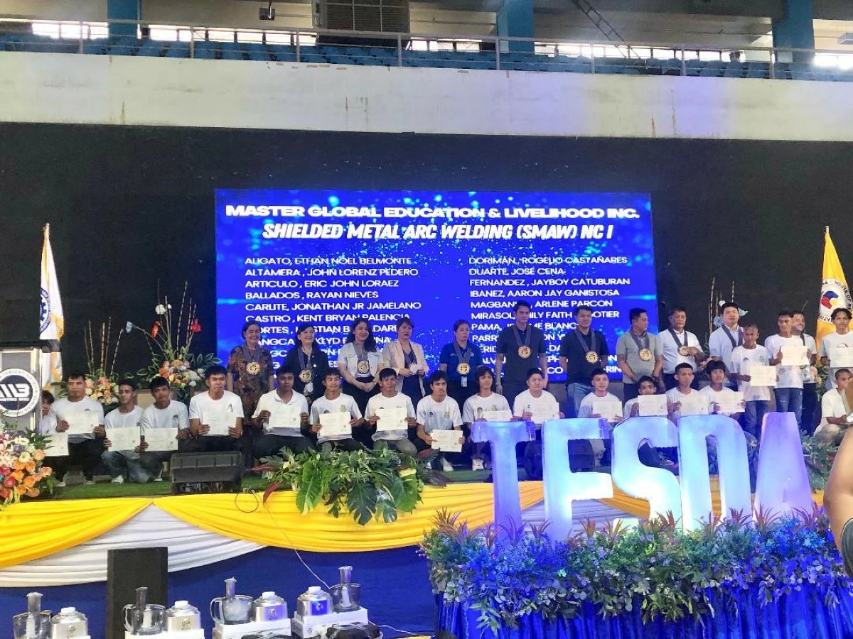 MORE than 2,000 residents of the third district of Negros Occidental graduate from the Technical Education and Skills Development Authority (TESDA) during a ceremony led by Rep. Javier Miguel Benitez (center) and TESDA-Negros Island Region (NIR) Director Niña Connie Dodd (fifth from left) at the Victorias City Coliseum in Victorias City on Thursday, May 7. (Glazyl Masculino)
