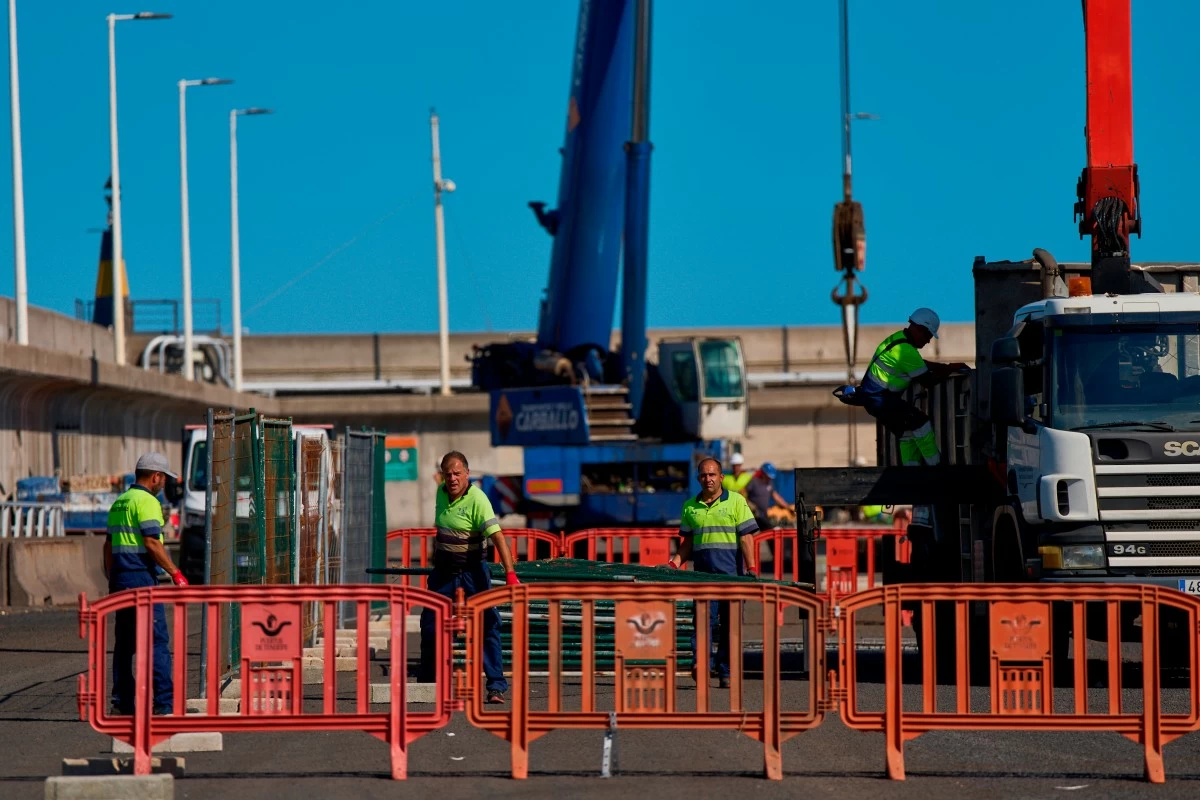 Workers prepare the area where passengers from the MV Hondius cruise ship are expected to arrive at the port of Granadilla in Tenerife, Canary Islands, Spain, Friday, May 8, 2026. (AP Photo/Manu Fernandez)