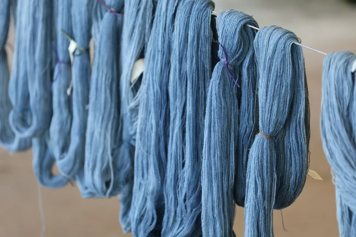 NEW COLORS — Cotton thread dyed with indigo left to dry.