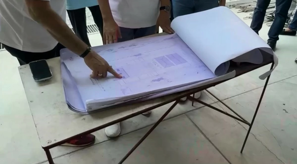 Domagoso, Atienza, and Andres review the school’s blueprint on-site to ensure construction progress remains aligned with the project plan.