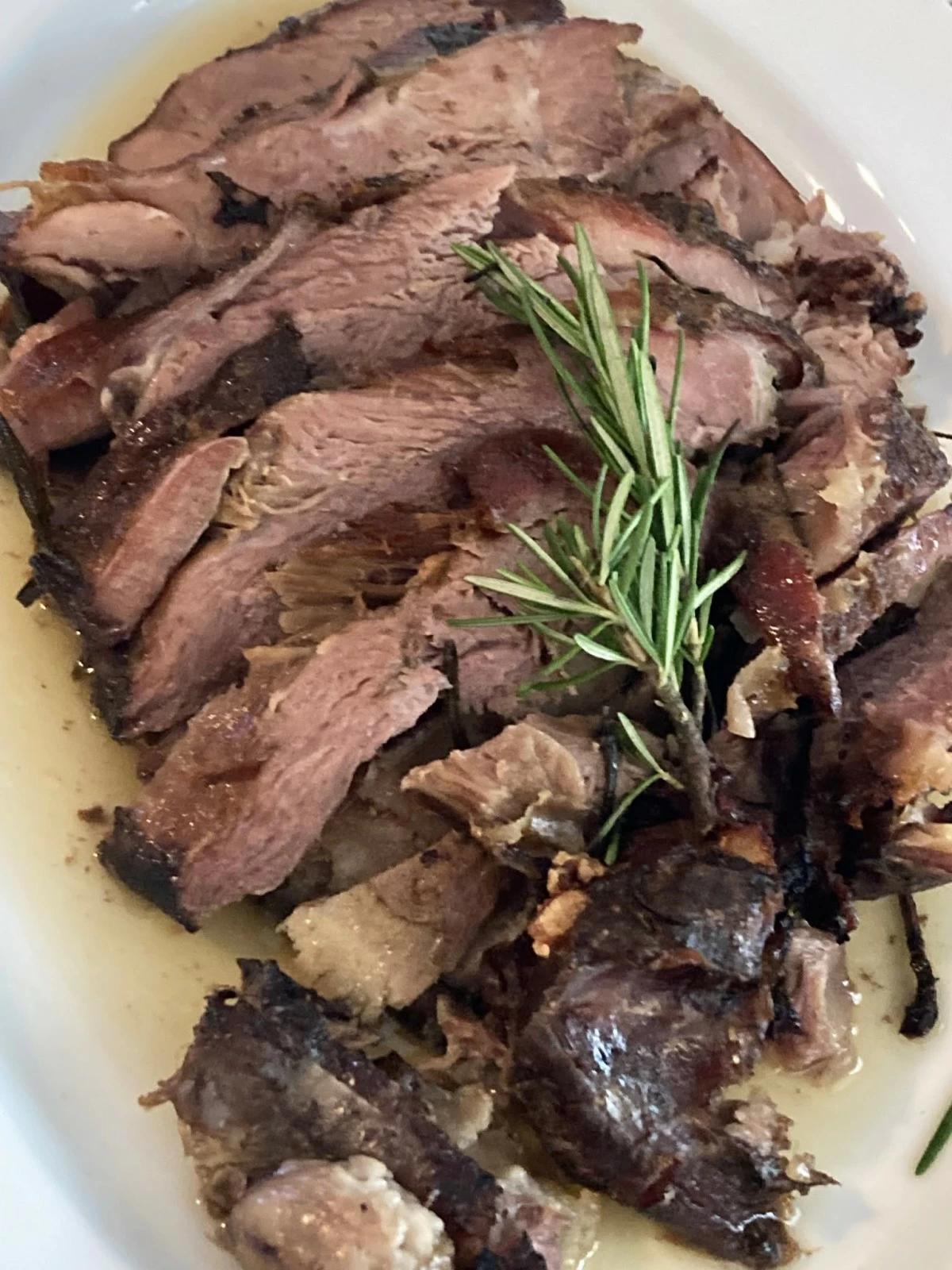 CORDERO LECHAL ASADO Oven roasted Australian suckling lamb with rosemary, garlic, and chimichurri sauce