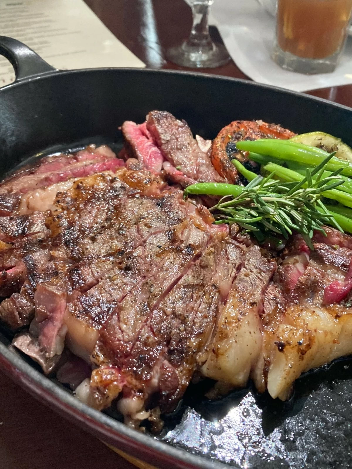 CHULETA DE LOMO ALTO CON HUESO Charcoal grilled bone in Stanbroke Farms Australian ribeye, roasted vegetables, thyme salt, and cooked in a custom Josper Oven