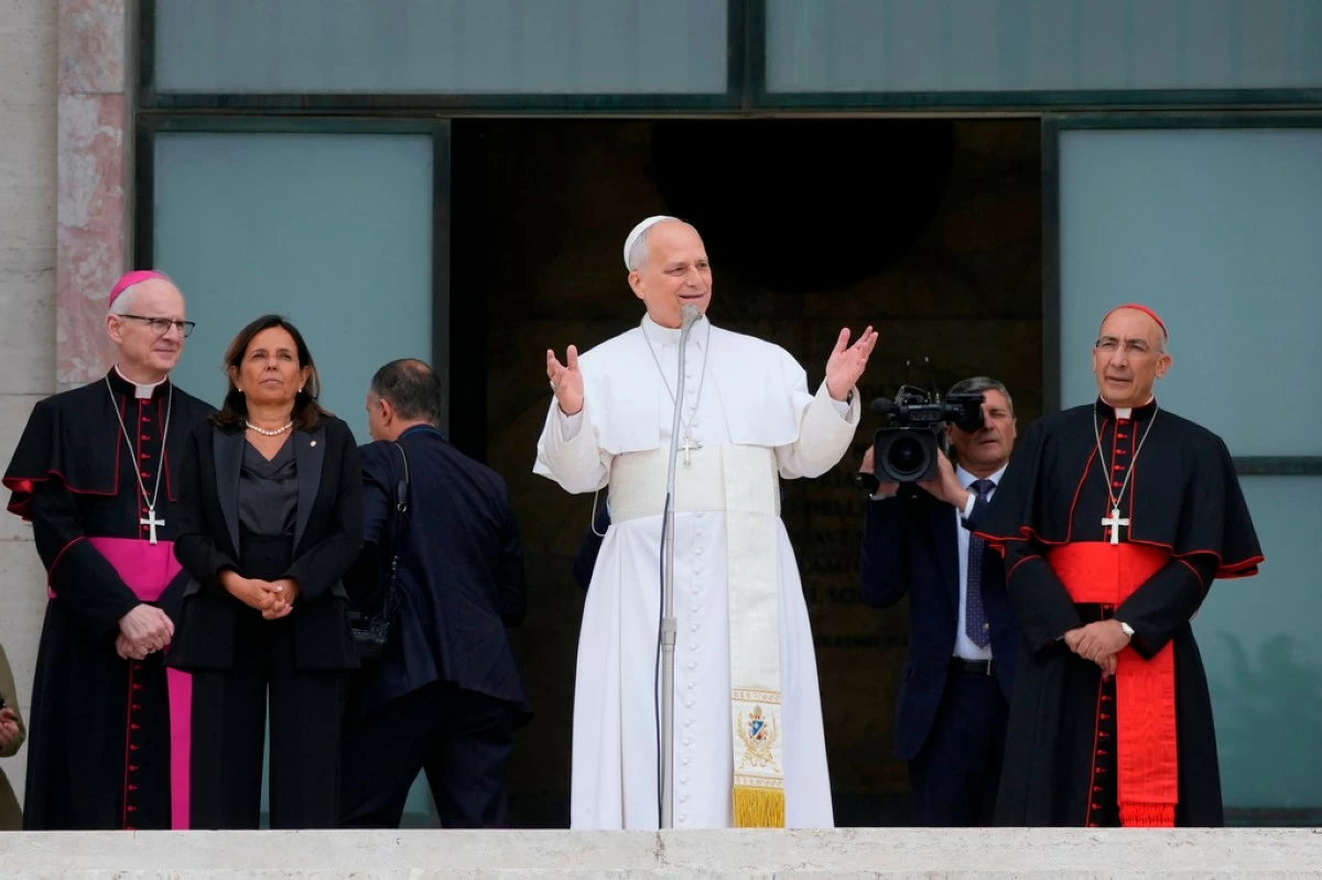 Pope Leo XIV, accompanied by, from left, Prefect of the Pontifical Household Archbishop Petar Rajič, Dean Antonella Polimeni, and his vicar for the city of Rome Cardinal Baldo Reina, visits the Città Universitaria (University City) at Sapienza University of Rome to meet with faculty and students at the institution's primary campus, one of the world's oldest and largest universities, Thursday, May 14, 2026. (AP Photo/Gregorio Borgia)