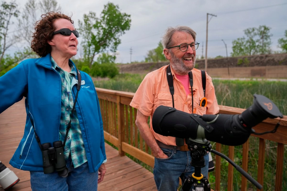 Birders Pat and Steve Pearson visit Park No. 597, where a pair of bald eagles are raising two eaglets, on the south side of Chicago, Tuesday, May 12, 2026. (AP Photo/Erin Hooley)