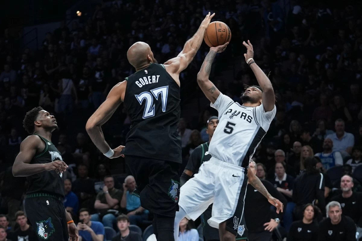 San Antonio Spurs guard Stephon Castle (5) shoots against Minnesota Timberwolves center Rudy Gobert (27) during the second half of Game 6 of an NBA basketball second-round playoffs series in Minneapolis, Friday, May 15, 2026. (AP Photo/Abbie Parr)