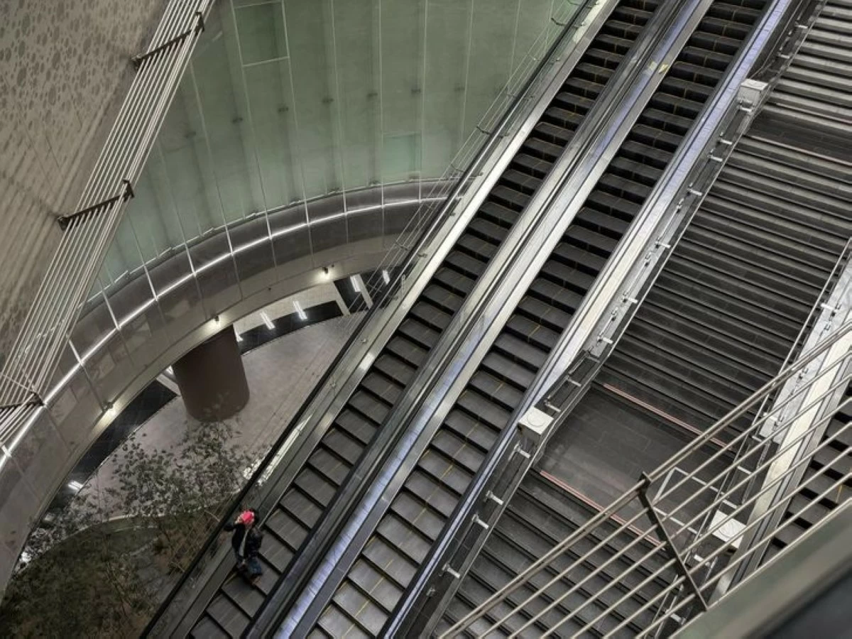 A commuter looks up to take a photo of Noksapyeong Station's glass domed ceiling in Seoul, Monday. (Photo: The Korea Times/Lee Hae-rin)