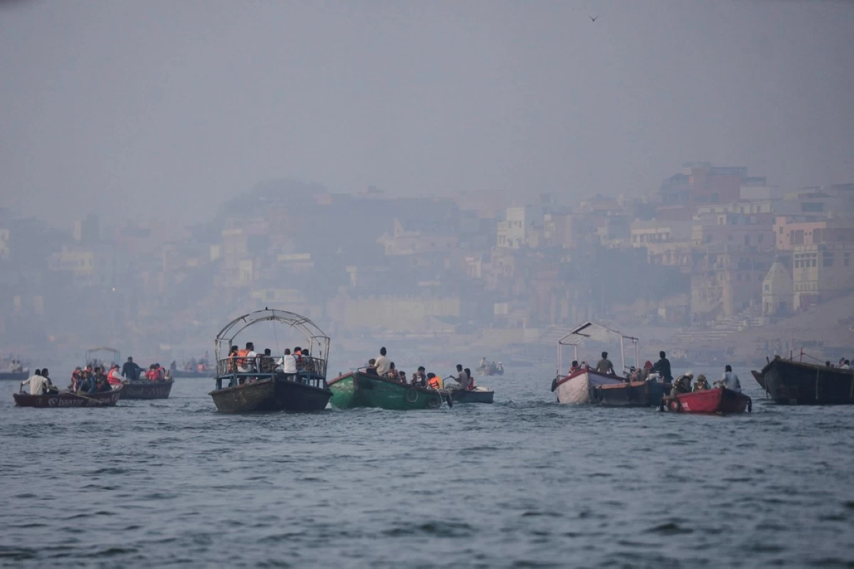 Tourists take a boat ride early morning in the Ganges river in Varanasi, India, March.16, 2026. (AP Photo/Channi Anand)
