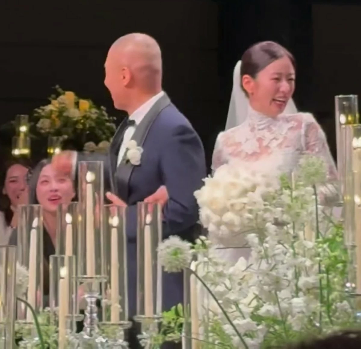 Apink's Bomi (right) and music producer Rado at their wedding on May 16 in Seoul (Screenshot from MakeupHyohyo's video on Instagram) 