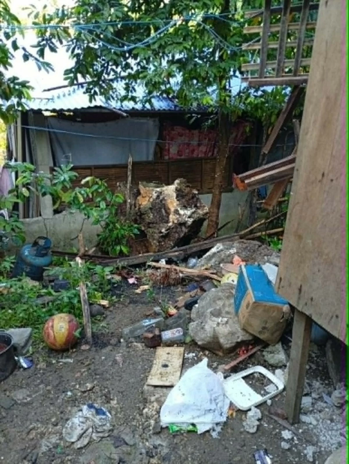 A portion of a house in Sitio Macopoy, Barangay Mascap, Rodriguez, Rizal was damaged after a large rock rolled down during a landslide incident on Saturday, May 17, leaving a woman dead and her two children injured. (Photo from Rodriguez Municipal Police Station)