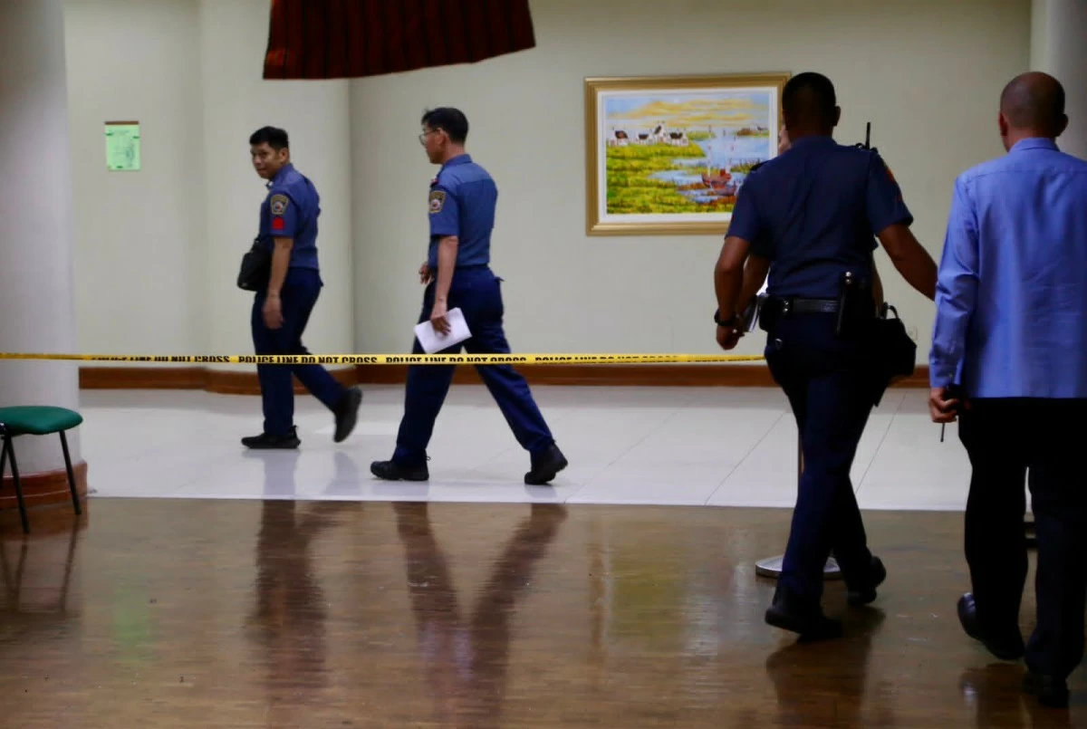 Philippine National Police personnel pass through a cordon leading to the Senate session hall in Pasay City following the May 13 shooting incident. Security forces tightened access as investigators continued their probe. (Photo by Mark Balmores)