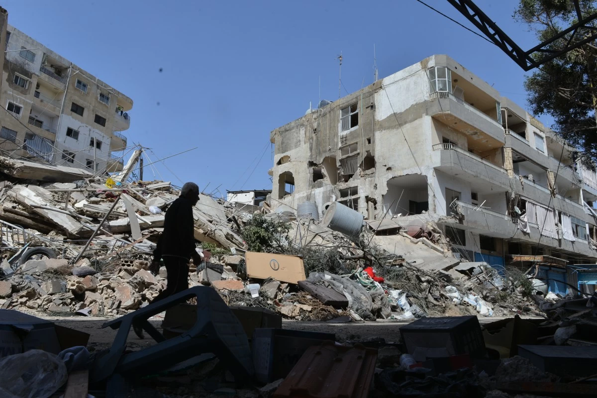 A man walks next to buildings destroyed in Israeli airstrikes the previous day in the southern village of Maarakeh, Lebanon, Sunday, May 17, 2026. (AP Photo/Mustafa Jamalddine)