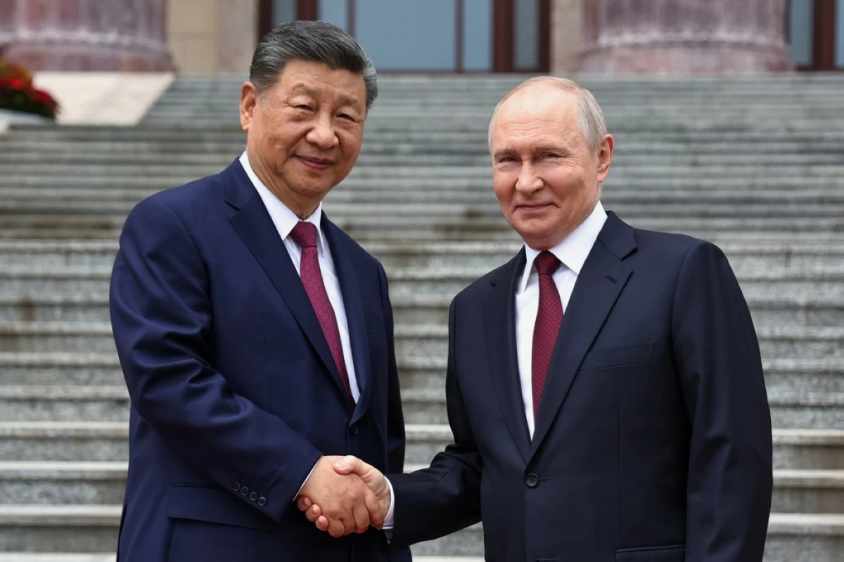 Russian President Vladimir Putin, right, and Chinese President Xi Jinping shake hands during a welcome ceremony at the Great Hall of the People, in Beijing, China, on Wednesday, May 20, 2026. (Alexander Kazakov, Sputnik, Kremlin Pool Photo via AP)
