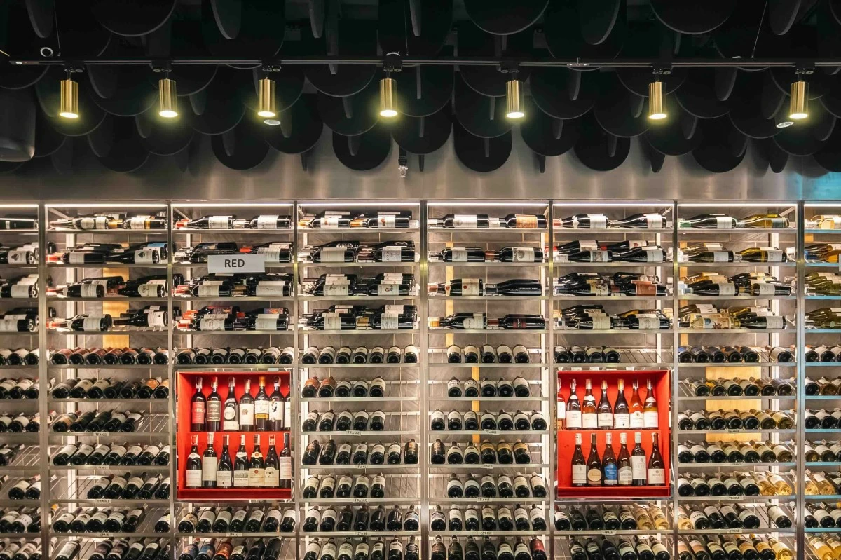 BOTTLED DISCOVERIES Rows of wine bottles line the shelves of World Cellar, the wine-centric concept inside Gateway Mall 2 that offers curated labels from wine regions around the world. (Photo: World Cellar)