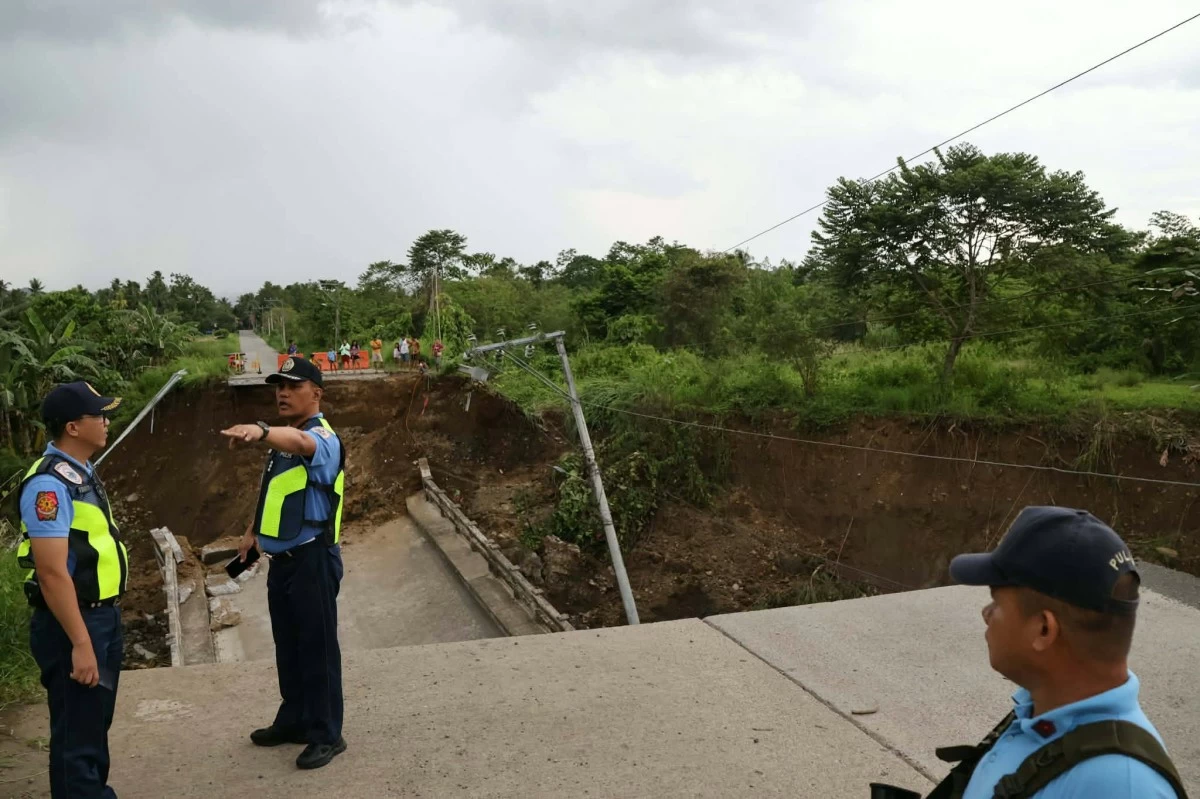POLICE secure a bridge that collapsed during bad weather in Davaao City. (DCPO FB) 