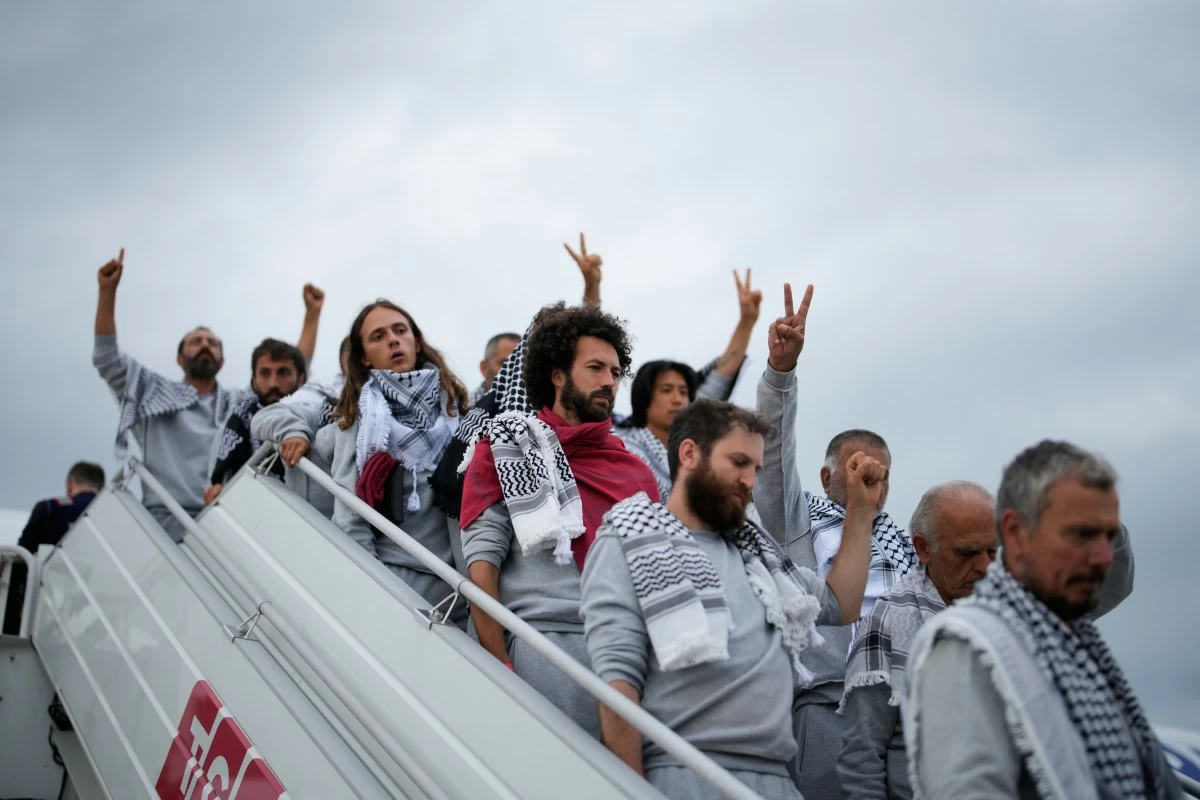Activists from the Global Sumud Flotilla disembark a plane upon arriving at Istanbul Airport, in Istanbul, Turkey, Thursday, May 21, 2026. (AP Photo/Emrah Gurel)