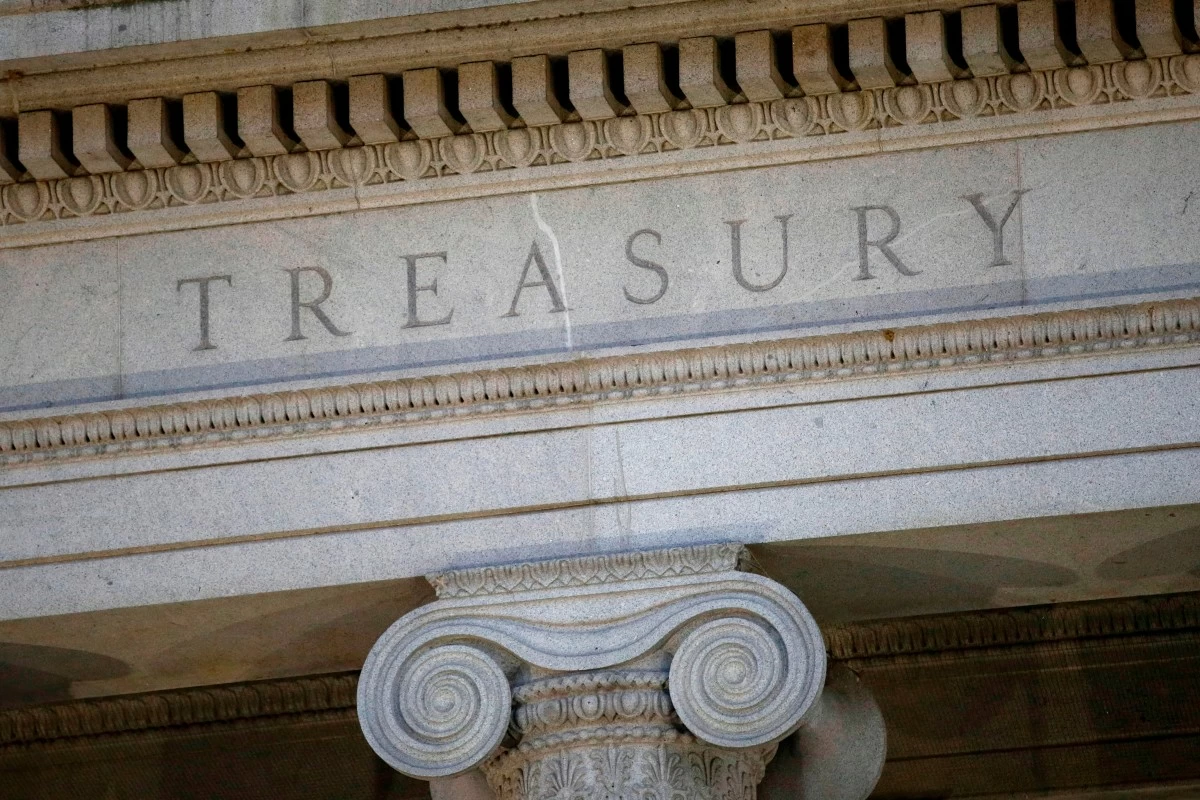 FILE - The Treasury Department building is pictured at dusk in Washington, June 6, 2019. (AP Photo/Patrick Semansky, File)