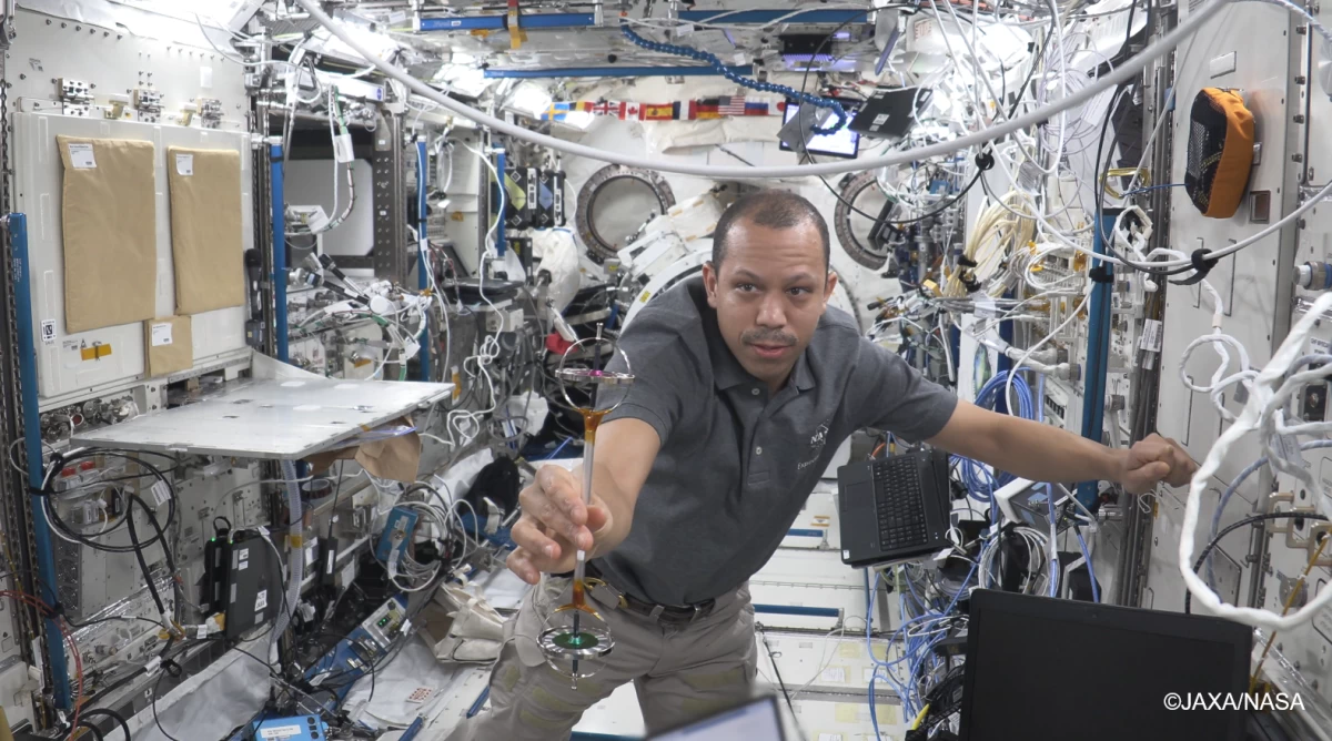 NASA astronaut Christopher Williams performs the Double Gyroscope experiment as part of the Asian Try Zero-G on the International Space Station (ISS). Photo courtesy of JAXA/NASA.