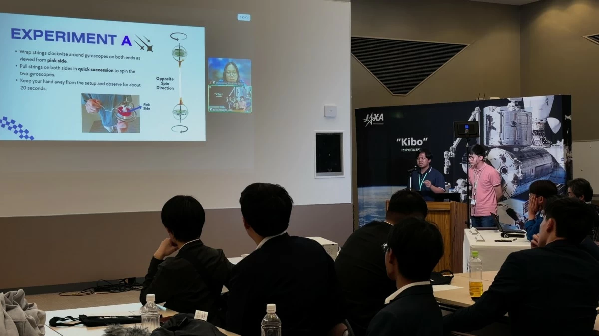 Facing the photo: (L) Christopher Tumamac and (R) Ryan Andrew Doña present their experiment proposal at the Tsukuba Space Center, Japan. 