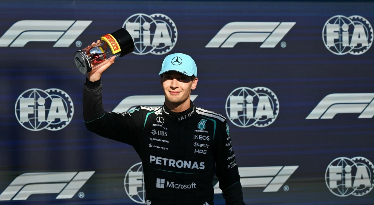 Mercedes driver George Russell of Britain holds up his trophy after taking pole following the sprint qualifying session at the F1 Canadian Grand Prix auto race in Montreal, Friday, May 22, 2026. (Graham Hughes/The Canadian Press via AP)