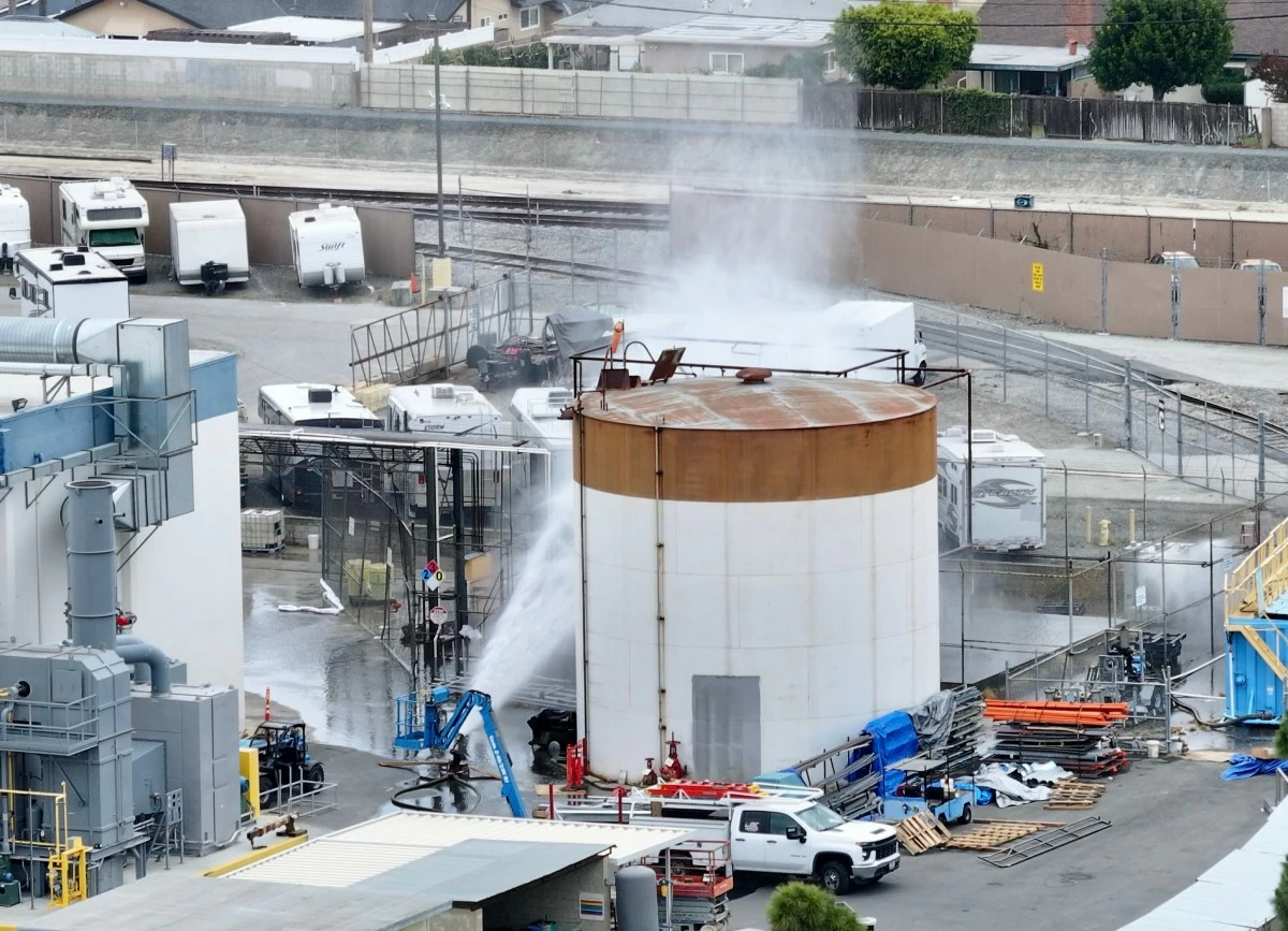 WATER is sprayed on a tank that overheated in an aerospace plant in Garden Grove, California, Friday, May 22, 2026. (Jeff Gritchen/The Orange County Register via AP)