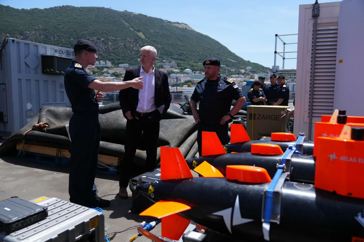 Britain's Armed Forces Minister Al Carns, centre, inspects autonomous vehicles with sonar sensor that can detect and identify mines, on RFA Lyme Bay in territory of Gibraltar, on Friday, May 22, 2026. (AP Photo/Kwiyeon Ha)