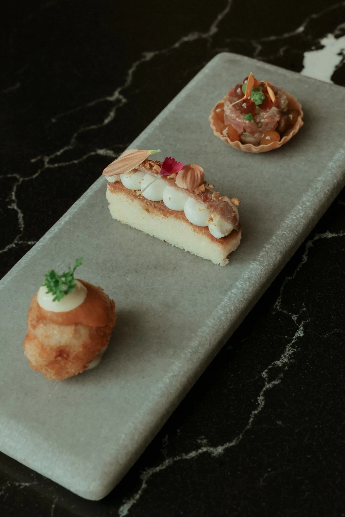 Cantabria's premium anchovy with Manchego mousse and pistachios, Northern Spanish chorizo with potato fritters, and wagyu and ikura tartlet