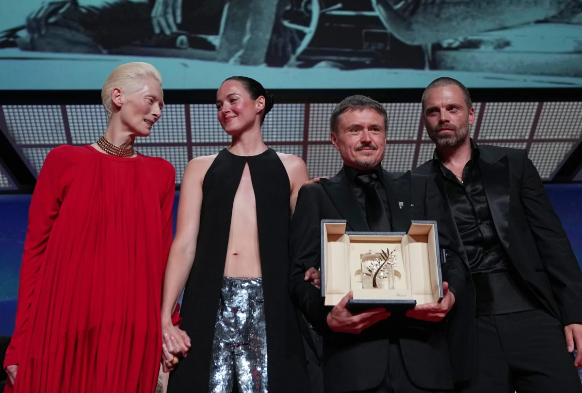 Tilda Swinton with Renate Reinsve, Cristian Mungiu, winner of the Palme d'Or for 'Fjord' and Sebastian Stan during the awards ceremony at the 79th international film festival, Cannes, southern France, Saturday, May 23, 2026. (AP Photo/Andreea Alexandru)