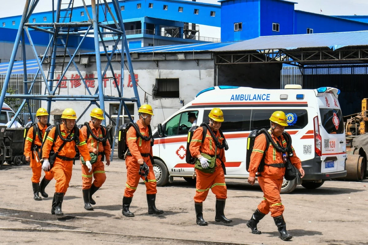 In this photo released by Xinhua News Agency, rescue workers pass by an ambulance in the aftermath of an explosion at Changzhi city's Liushenyu coal mine in Qinyuan county, northern China's Shanxi Province on Saturday, May 23, 2026. (Cao Yang/Xinhua via AP)