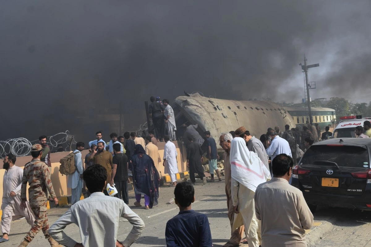 Paramilitary soldiers and volunteers recover victims from an overturned train coach on a railway track at the site of bomb explosion, in Quetta, Pakistan, Sunday, May 24, 2026. (AP Photo/Arshad Butt)