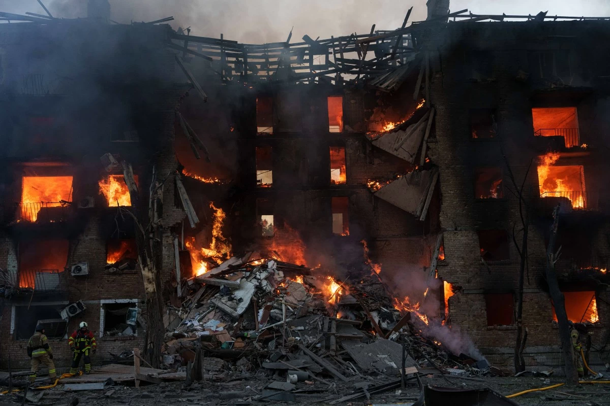 Rescue workers put out a fire of residential building destroyed after a Russian strike in Kyiv, Ukraine, on Sunday, May 24, 2026. (AP Photo/Evgeniy Maloletka)