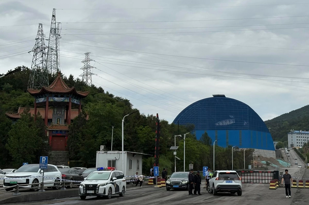 Police officers at a checkpoint stop cars at the entrance to the Liushenyu coal mine facility in Qinyuan county in Changzhi, northern China's Shanxi province on Sunday, May 24, 2026. (AP Photo/E. Eduardo Castillo)