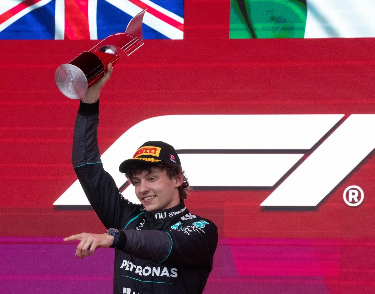 Mercedes driver Kimi Antonelli, of Italy, lifts his trophy following his win in the F1 Canadian Grand Prix auto race in Montreal, Sunday, May 24, 2026. (Christinne Muschi/The Canadian Press via AP)