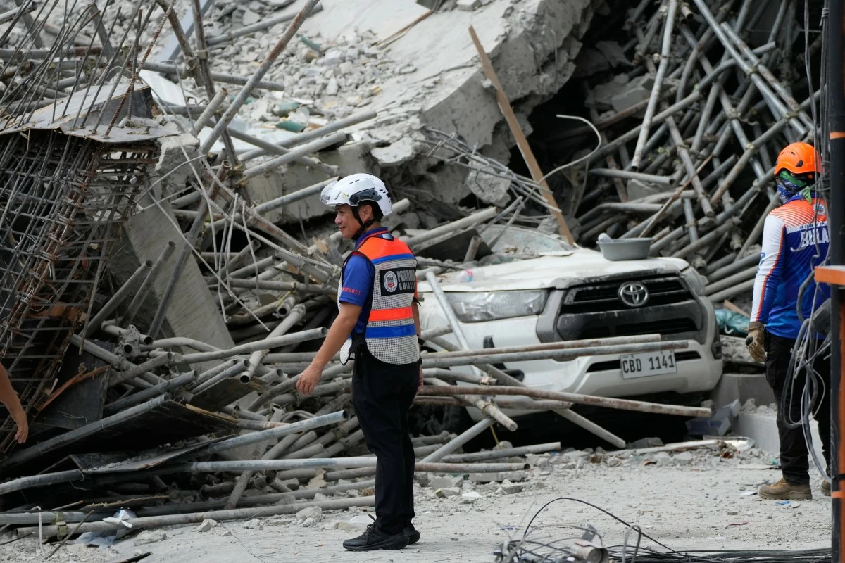 

RESCUERS stand beside ruins as search operations continue in a collapsed building in Angeles City in Pampanga, Monday, May 25, 2026. (AP Photo/Aaron Favila)
