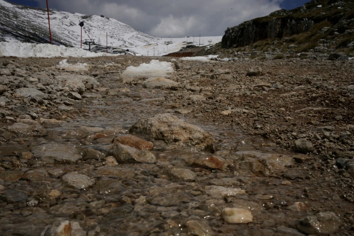Water from melting snow flows down the slopes of Mount Parnassos at the Kelaria ski center in central Greece, on May 5, 2026. (AP Photo/Thanassis Stavrakis)