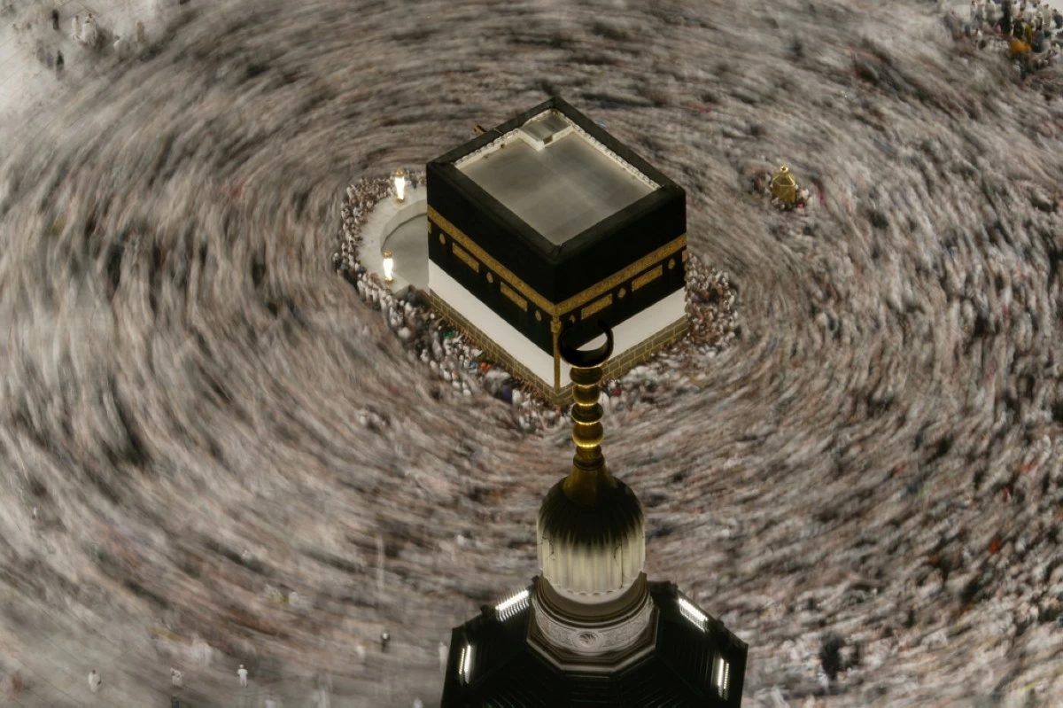 This photograph made with a slow shutter speed shows Muslim pilgrims circumambulating the Kaaba, Islam's holiest site at the Grand Mosque during the annual Hajj pilgrimage in Mecca, Saudi Arabia, Sunday, May 24, 2026. (AP Photo/Altaf Qadri)