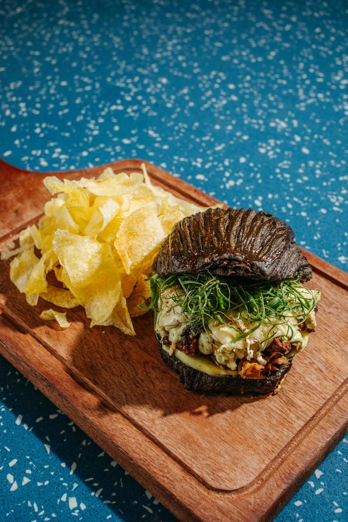 SINFUL PASTRY The Pork & Brie 'Pain' au Chocolat combines black cacao croissant with braised pulled pork, Brie de Meaux, calamansi kosho, and daikon (Photo: Arabella Paner)