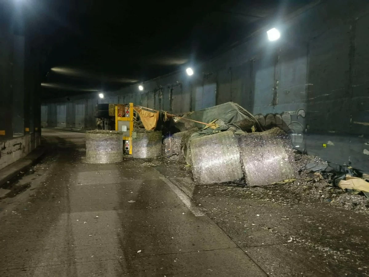 An overturned garbage truck is seen blocking part of the C5-Bonny Serrano Tunnel in Quezon City following an early morning accident on Wednesday, May 27. (Photo courtesy of the Metropolitan Manila Development Authority)