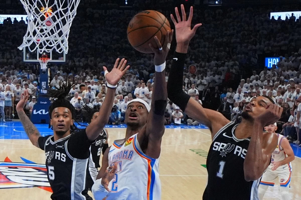 Oklahoma City Thunder guard Shai Gilgeous-Alexander (2) shoots against San Antonio Spurs forward Victor Wembanyama (1) in the second half of Game 5 in the Western Conference finals NBA basketball playoffs series, Tuesday, May 26, 2026, in Oklahoma City. (AP Photo/Julio Cortez)